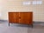 This elegant sideboard, designed by Scanform and made in Denmark, is crafted in warm teak and showcases the refined...