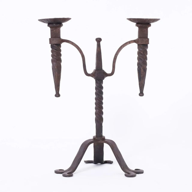 Standout pair of 19th century French hand wrought iron candle sticks each with two candle holders attached to a twisted...