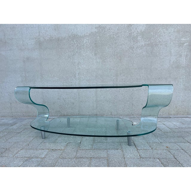 Beautiful coffee table in curved crystal glass. A design by Elio Vigna from the 1990s for FIAM. Model is no longer made....