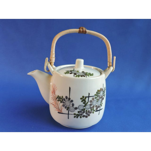 This Japanese porcelain hand painted bamboo handled teapot was made by the Kutani Ware Co. from Japan and it was produced...