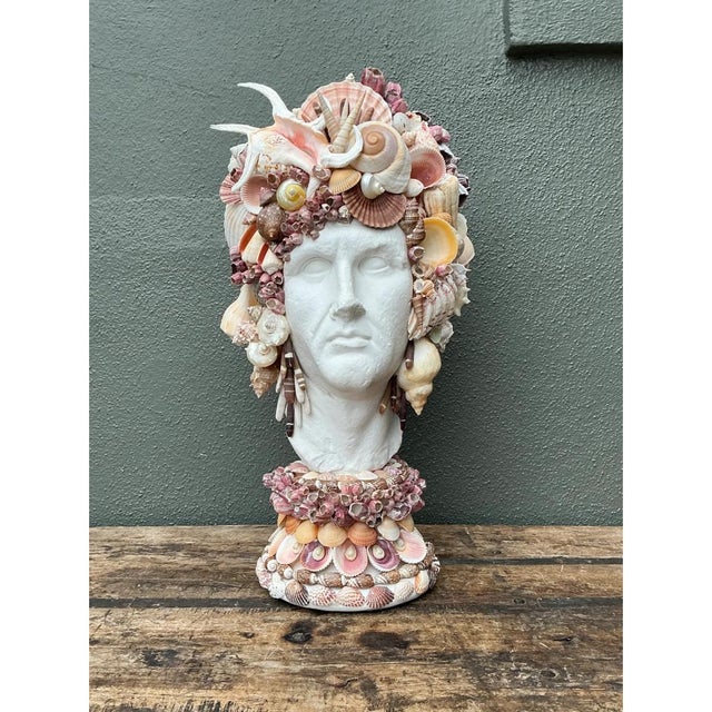 This vintage plaster bust presents a striking marriage of classical form and natural coastal artistry, its smooth,...
