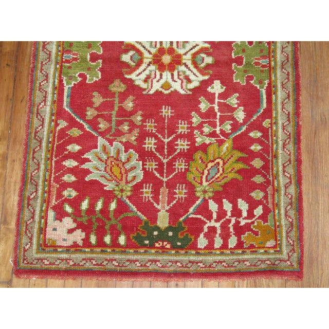 A colorful Turkish Oushak throw rug. Predominantly bright reds and greens, circa 1930. Measures: 3'3'' x 5'.