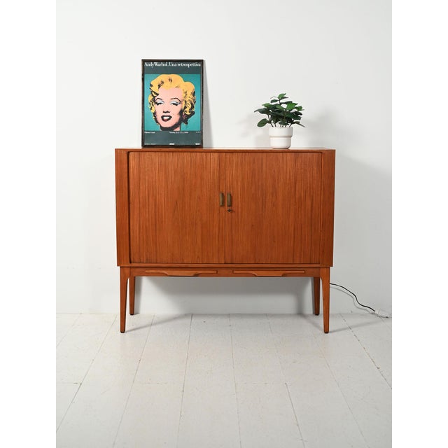 A rare 1960s Scandinavian bar cabinet, attributed to Kurt Østervig, in teak veneer with refined interior organization and...