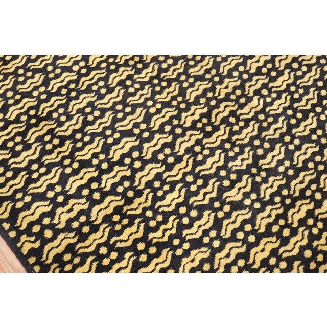 A midcentury handmade Turkish deco rug in black and yellow. Measures: 7'1'' x 10'2''.