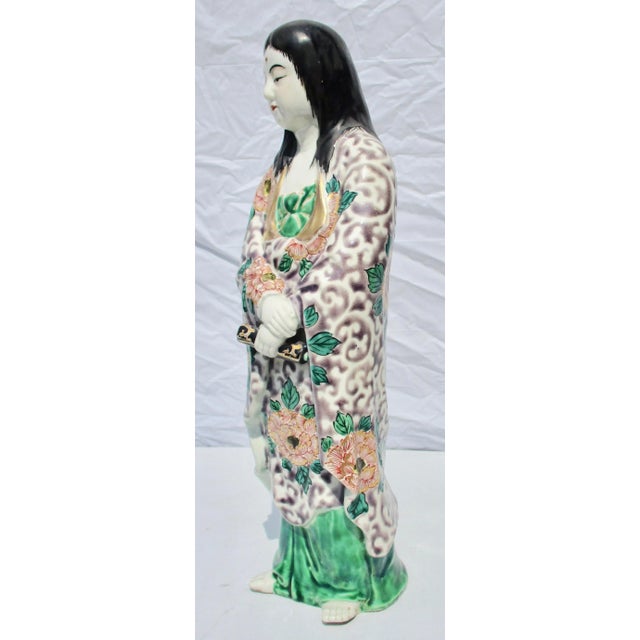 Japanese turn of twentieth century porcelain Kannon. Beautiful robes and calm demeanor . Size 13" tall, 5" by 4" overall.