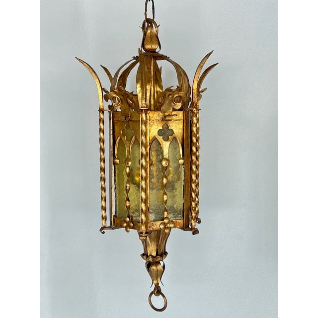Pair Italian Mid-Century Gothic Revival tole hanging lanterns featuring a gilt gold finish with hints of the traditional...