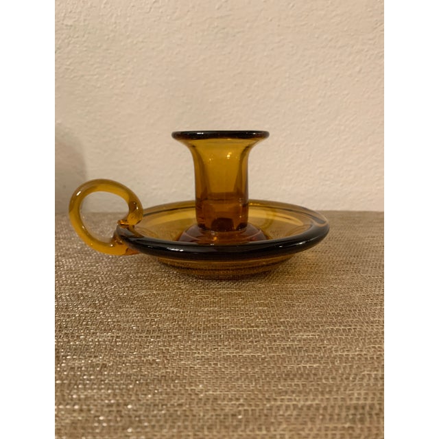 This is a beautiful candelabra with holder in amber glass, signed.