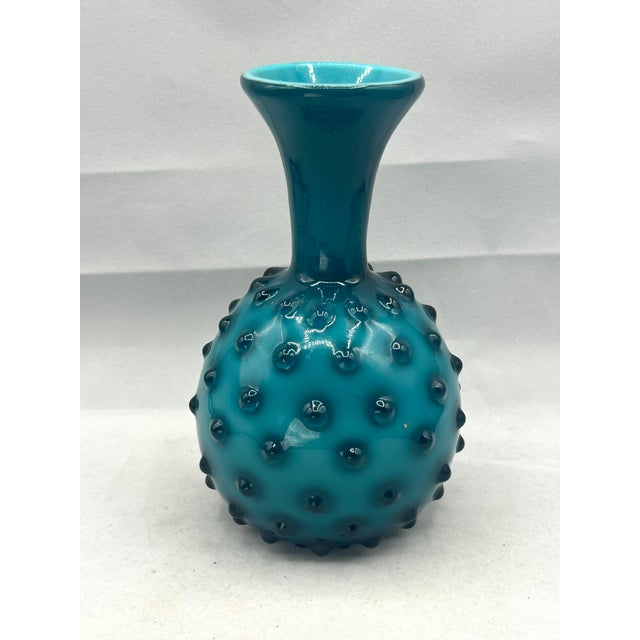 Mid-Century Modern Italian art glass vase from the Empoli region, featuring a vivid teal-blue cased glass body with raised...