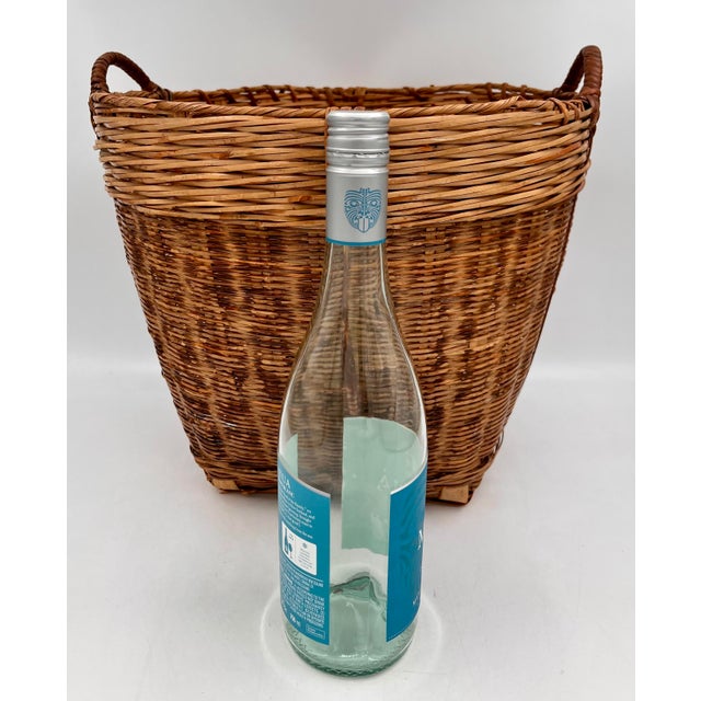 Beautiful handcrafted split-reed, burnt tortoiseshell bamboo, and rattan wicker large gathering basket with a tapered base...