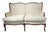 An elegant upholstered camelback loveseat by Southern Furniture Co. of Conover, North Carolina, Featuring a gracefully...