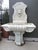 Hand-carved in three sections of white marble, this Italian wall fountain from the 1900s features a lion mascaron water...
