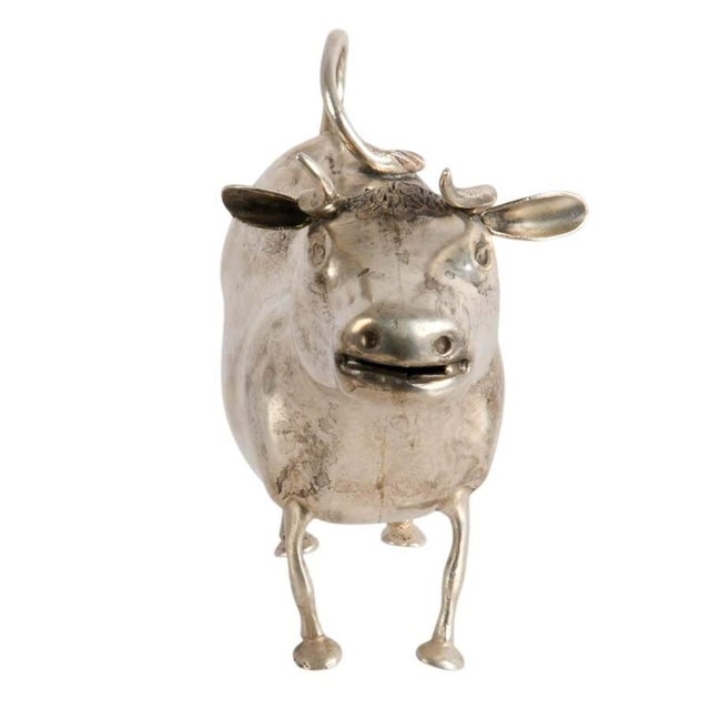 This Antique Dutch 930 Silver Figural Cow Creamer is a delightful example of the whimsical yet highly skilled silverwork...