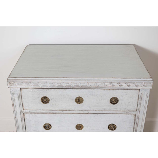 A refined 20th-century Swedish Gustavian-style chest of drawers, showcasing the timeless elegance and craftsmanship of...