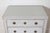 A refined 20th-century Swedish Gustavian-style chest of drawers, showcasing the timeless elegance and craftsmanship of...
