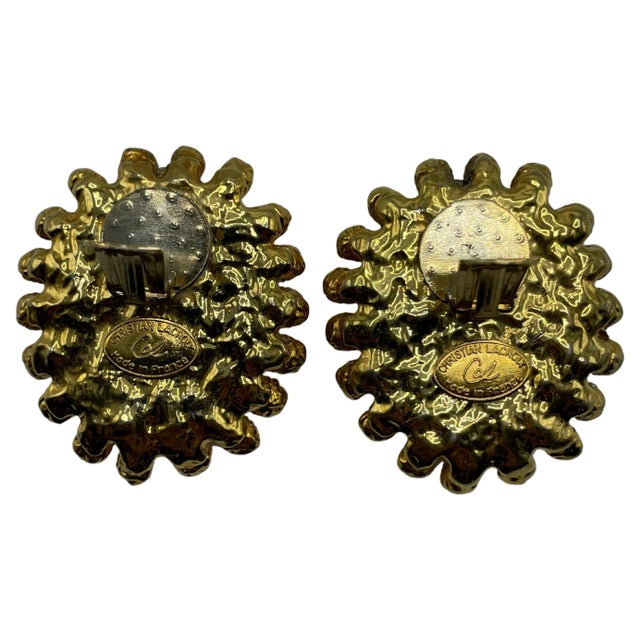 Huge set of gold clip-on earrings engraved with the initials CL on the front loops and marked Christian Lacroix. Made in...