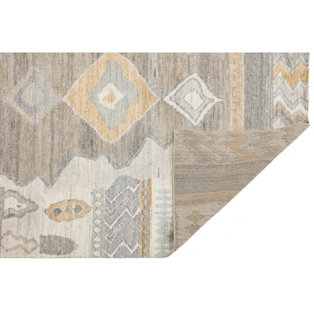 This stunning area rug seamlessly blends ancient North African weaving traditions with a sophisticated, contemporary color...