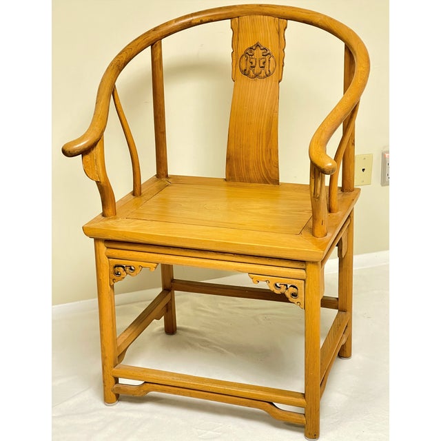 This is an antique elm wood chair made in China in the late 19th century. It is elm throughout with paneled seat,...