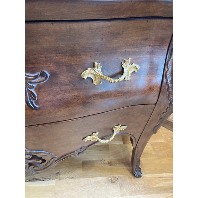Made in Italy, this beautifully crafted dresser features a gently curved front, intricate carved floral motifs, and richly...