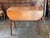 A 19th century Pembroke table with two drop leaves with rounded corners, a single dovetailed drawer with a brass swing...