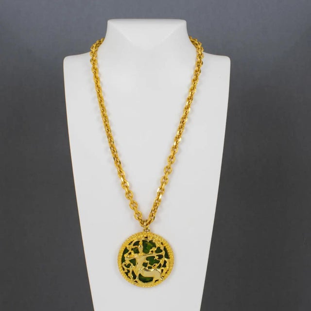 This spectacular Pauline Rader necklace features an important, dimensional pendant design with shiny, gilded metal framing...