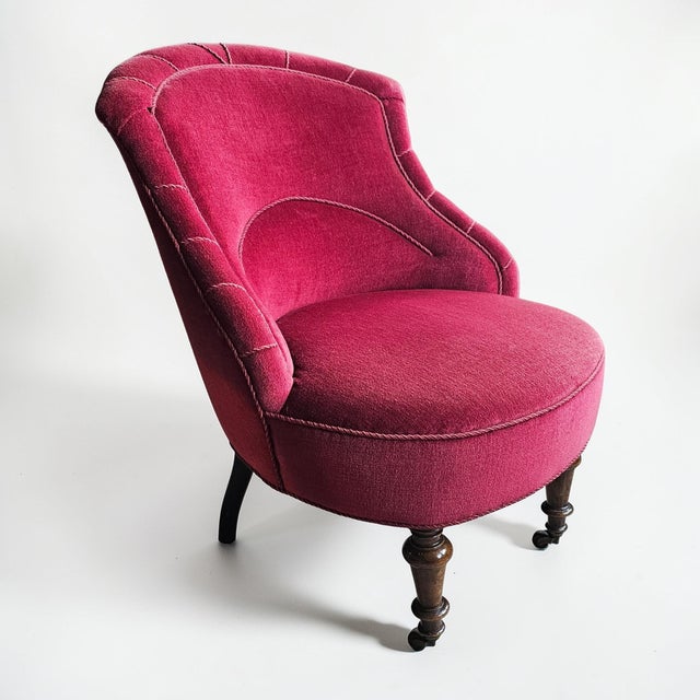 Elegant Swedish Grace slipper chair from the 1920s featuring a sculptural curved back, braided trim detailing, and turned...