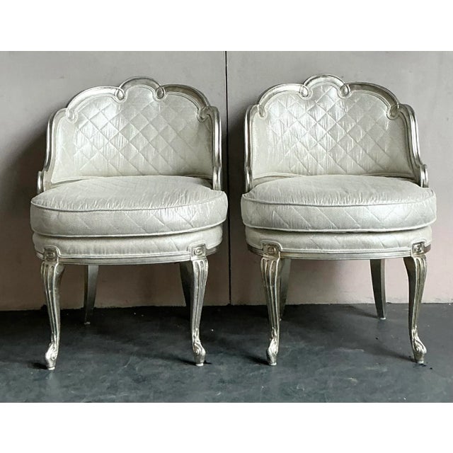 Presenting a stunning pair of vintage lounge chairs, exuding the opulent charm of Regency and Baroque design. These chairs...