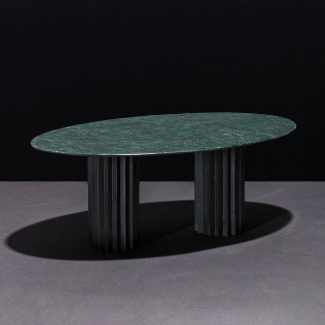 Dining table with green Serpentino marble top and multifaceted pedestals in cast blackened bronze. Inspired by Doric...