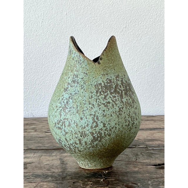 This evocative original studio pottery vase is a masterclass in organic modernism, showcasing the experimental spirit of...