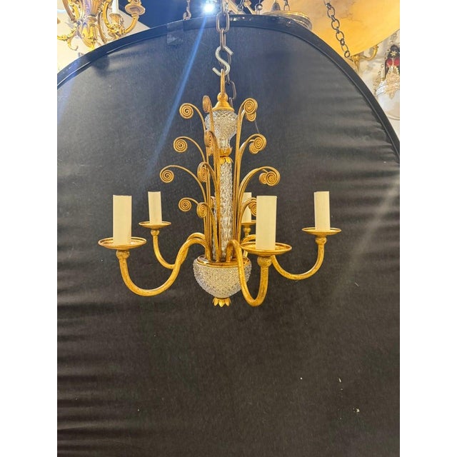 A circa 1930’s French gilt metal chandelier with crystal parts. 5 lights