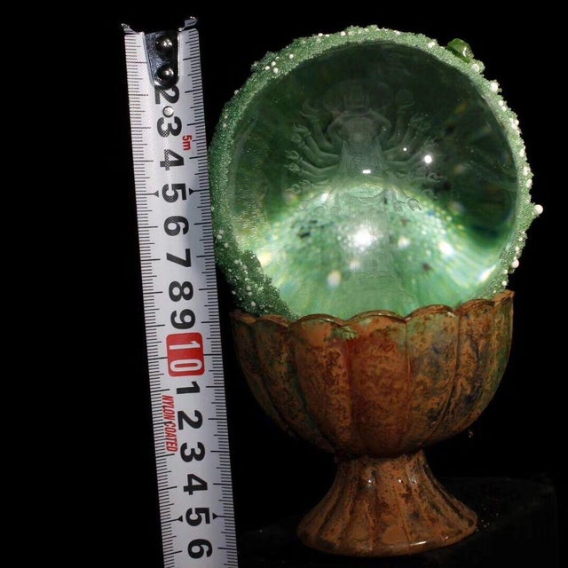 This is a rare and unusual Buddhist relic sphere, described as a "regenerated sarira" containing an etched image of a...