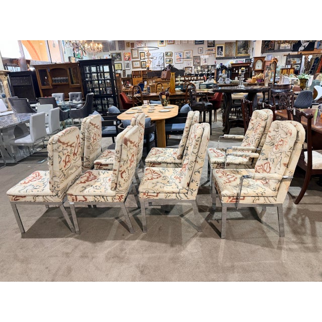A bold and artful take on classic Mid-Century Modern design, this striking set of eight dining chairs—attributed to Milo...