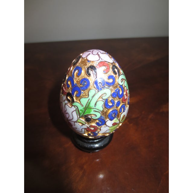 Cloisonné Egg With Stand The lovely cloisonné egg features a lotus blossom and leaves. It is in excellent condition and...