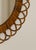 Round rattan wall mirror with looped petal frame. Italian Mid Century, circa 1960s. Original mirror glass.
