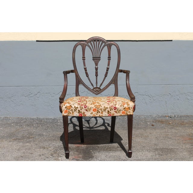 A single c1950's heavily and masterfully carved Sheraton style Arm Chair/ Occasional Chair. Textile is original and in...