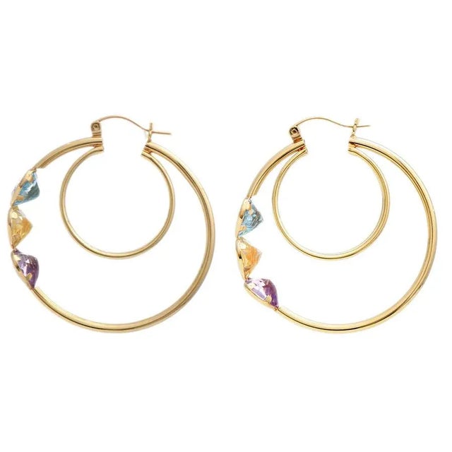 There is something so wholesome and heavenly about these heart hoop earrings. Featuring three tantalizing topaz stones...