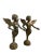 A fine pair of french bronze cherubs standing contrapposto, both extending an arm, each of which is holding a bunch of...