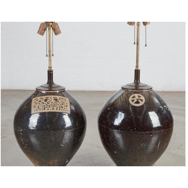 This is an unusual pair of lamps that have been created with antique 19th century Chinese storage jars an are attributed...