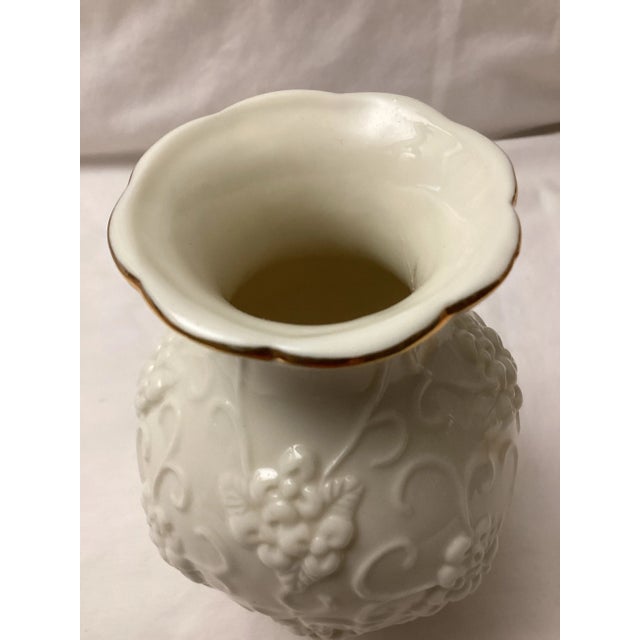 This beautifully crafted vase has the sleek elegance of mid-century modern design. The gold rim is adorned with a charming...