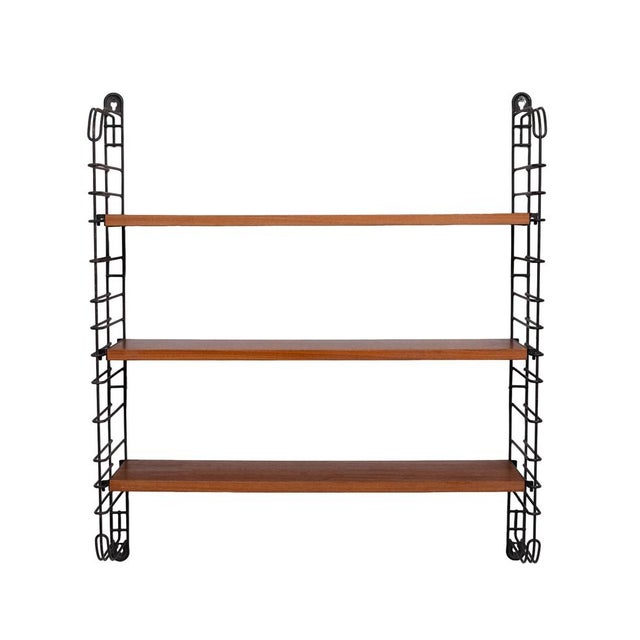 Tomado wall shelf from the 50s, it is made up of 2 black metal uprights dyed in the mass and stamped + 3 teak wood shelves...