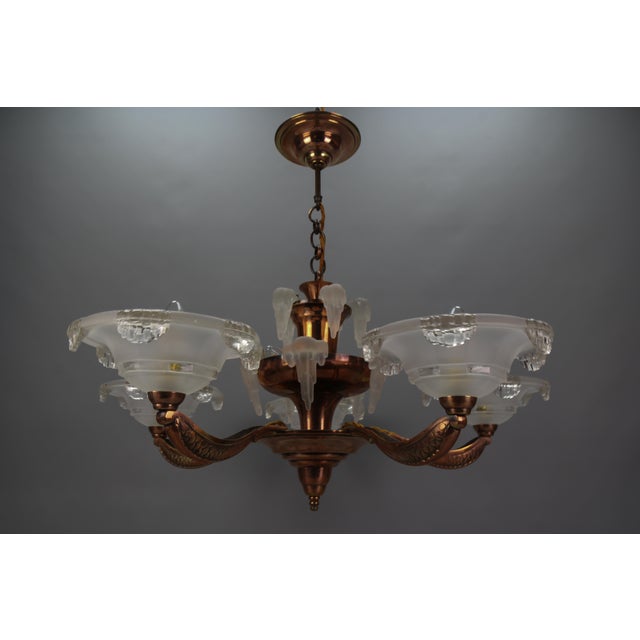 French Art Deco 7-light frosted glass, brass, and copper chandelier, circa the 1930s. This magnificent chandelier,...