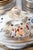The dinnerware set consists of 81 pieces, all hand-painted. Each piece is signed "made by Izo". 20 dinner plates: 24.2 cm...