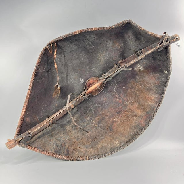 A leather shield with a wooden handle. The Maasai people, as you mentioned, are an ethnic group of Nilotic origin...