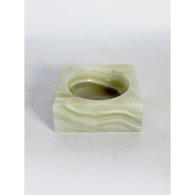 A French ashtray from the 1950s, crafted from a single block of green onyx with stunning, undulating natural veins. Its...
