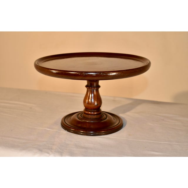 19th century mahogany pedestal from England. The top has a pie crust edge surrounding the top, which is supported on a...