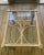 Offering a vintage rattan table with an interesting design and beachy white-washed finish and custom glass top.
