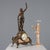Clock in patinated antimony bronze and marble. A rocaille-decorated base features a figure depicting the allegory of...