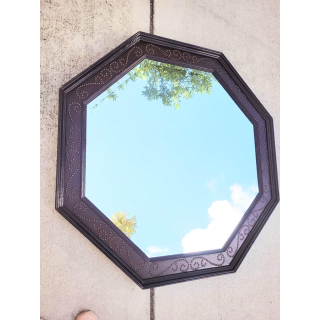 A massive faux leather octagonal wall mirror with antique stud design. The mirror is made of a real wood surround with a...