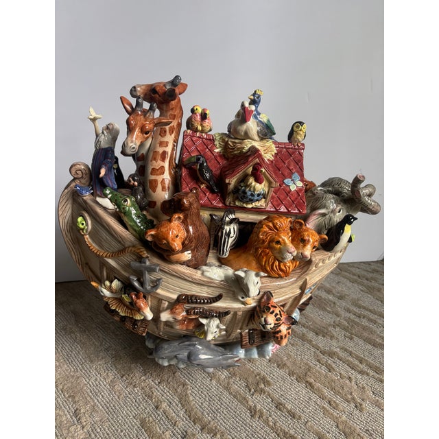 A whimsical ceramic hand-painted Noah's Ark by Fitz & Floyd, large scale at 17" tall with colorful animals poking out of...