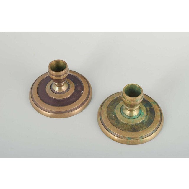 Cawa, denmark. pair of brass candlesticks, art deco, 1940s. solid brass candlesticks with circular base and geometric ring...