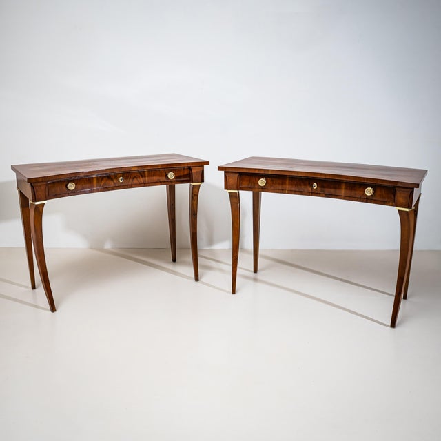 Pair of exceptional Italian consoles of concave form with brass decoration and a single drawer each. The consoles stand on...